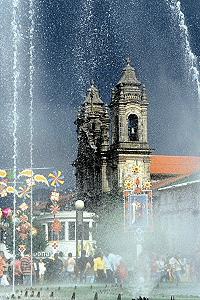 One of the many churches of Braga through a veil of water from a fountain on the main plaza